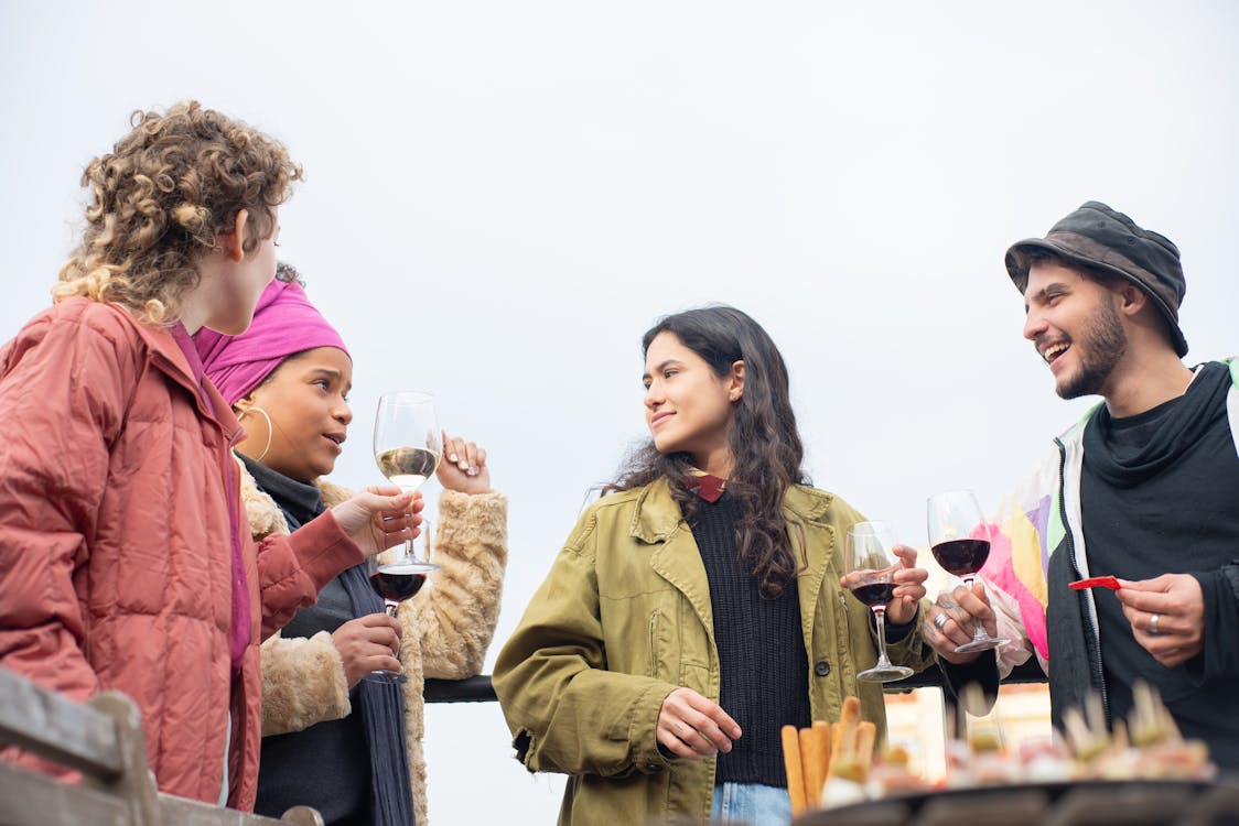 Young wine enthusiasts enjoying wine at a social gathering